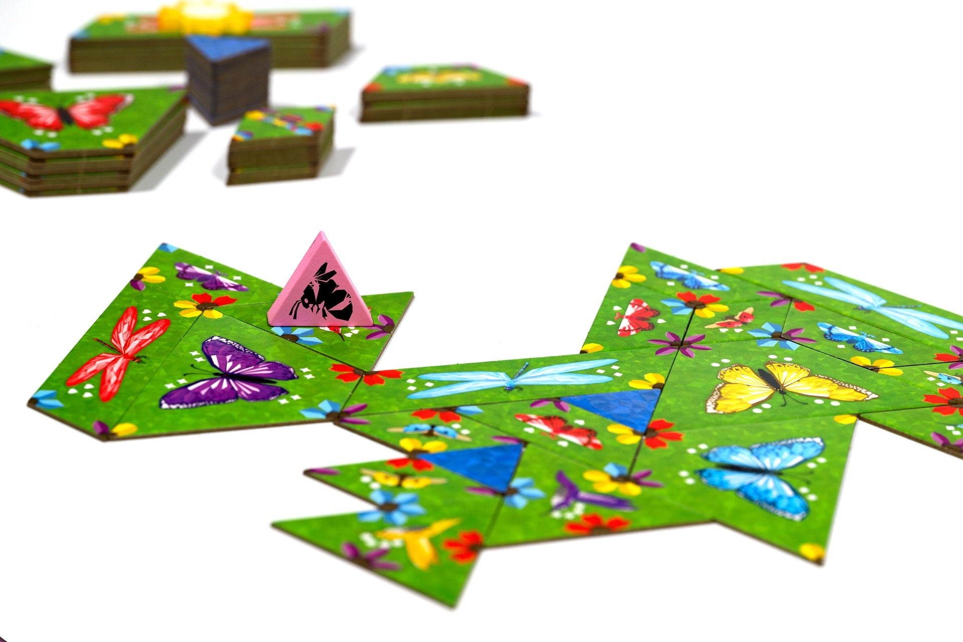 Colorful butterfly-themed game pieces on green cards with a white background