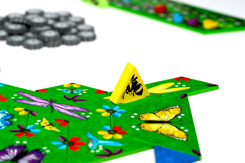Colorful butterfly-themed board game with game pieces on a white surface